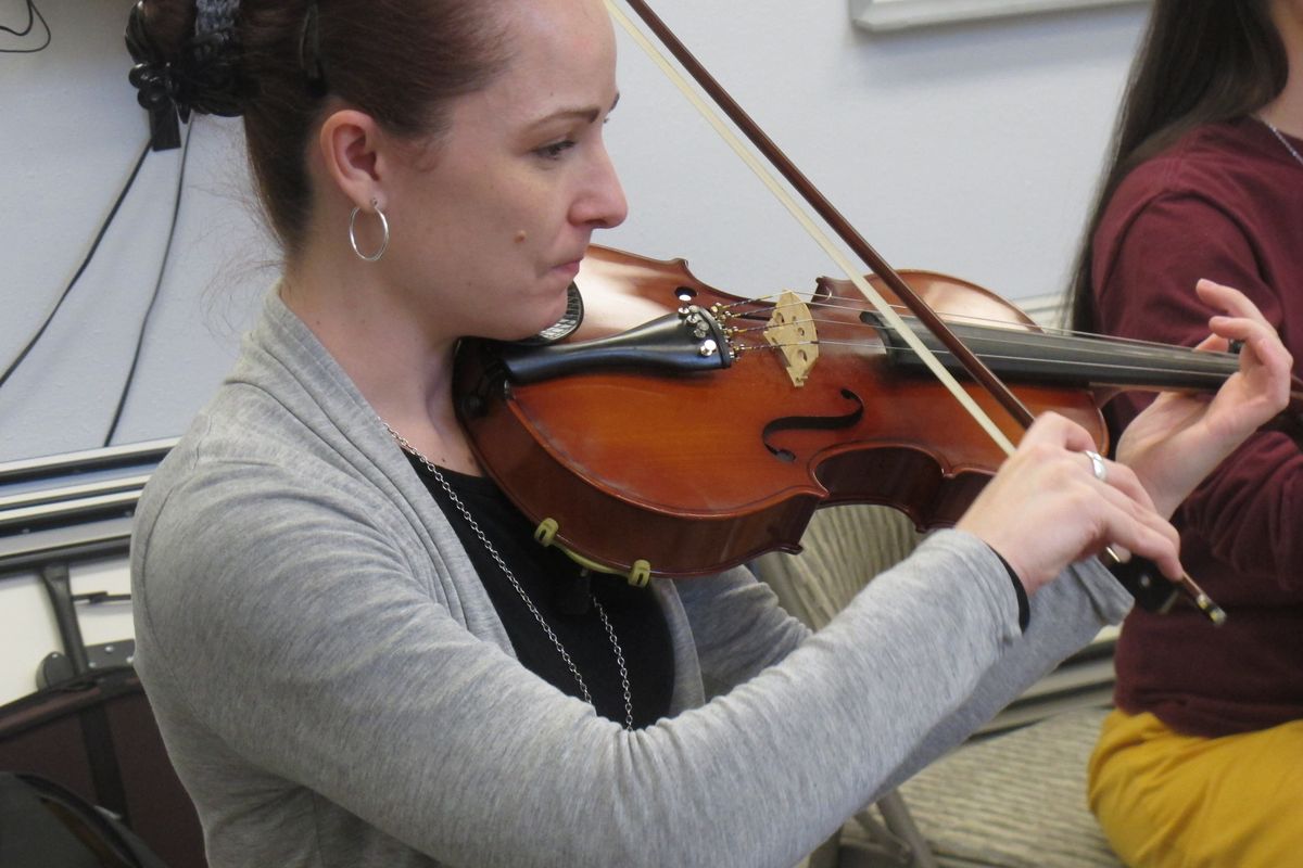 In this Nov. 17, 2012, photo, Sarah Jane Coffman practices the viola with the Hiland Mountain Correctional Facility Orchestra in Eagle River, Alaska. After serving a 14-year sentence for murder, Sarah Jane Coffman, a founding member of the women