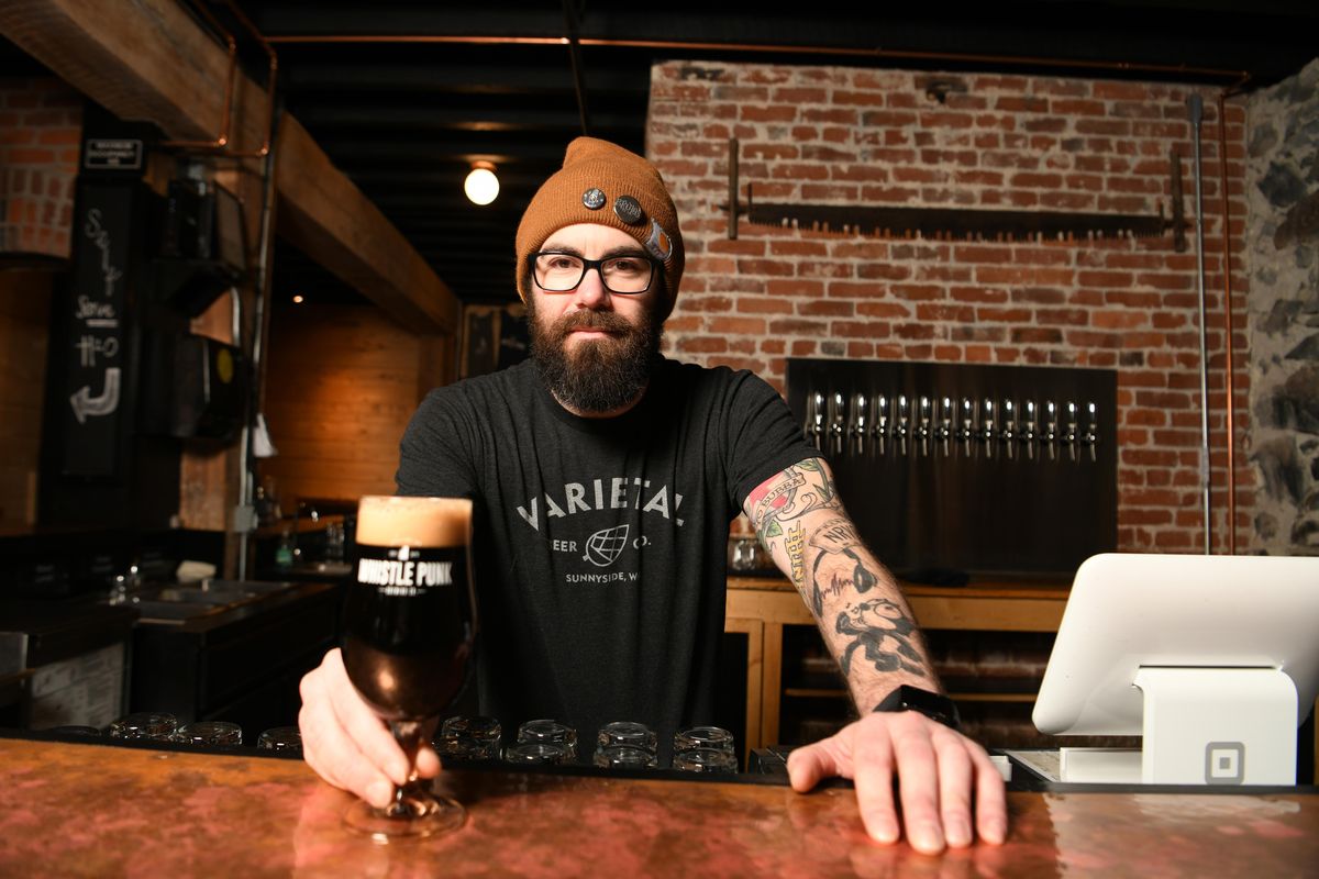 Taproom manager Chris Harnett offers up an espresso milk stout, which has a distinct coffee flavor in its profile on Tuesday, March 12, 2019 at the Whistle Punk Brewing Co. tap room in downtown Spokane. (Jesse Tinsley / The Spokesman-Review)