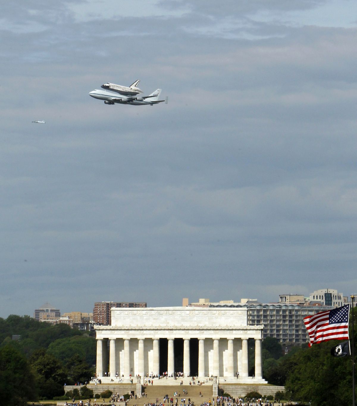 The Space Shuttle Discovery, mounted on the Shuttle Carrier Aircraft, flies over the Lincoln Memorial in Washington, Tuesday, April 17, 2012. Discovery is en route from Kennedy Space Center to the Smithsonian National Air and Space Museum Udvar/Hazy Center at Dulles International Airport. (Ann Heisenfelt / Fr13069 Ap)