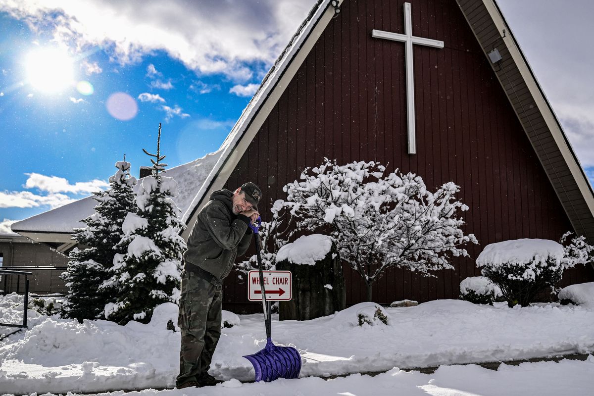 “She’s well over 100 years old,” congregant Mark Wisher says on Thursday about Otis Orchards Community Church while taking a rest from shoveling.  (Kathy Plonka/The Spokesman-Review)