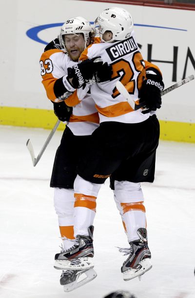 Flyers’ Jakub Voracek, left, celebrates hat trick. (Associated Press)