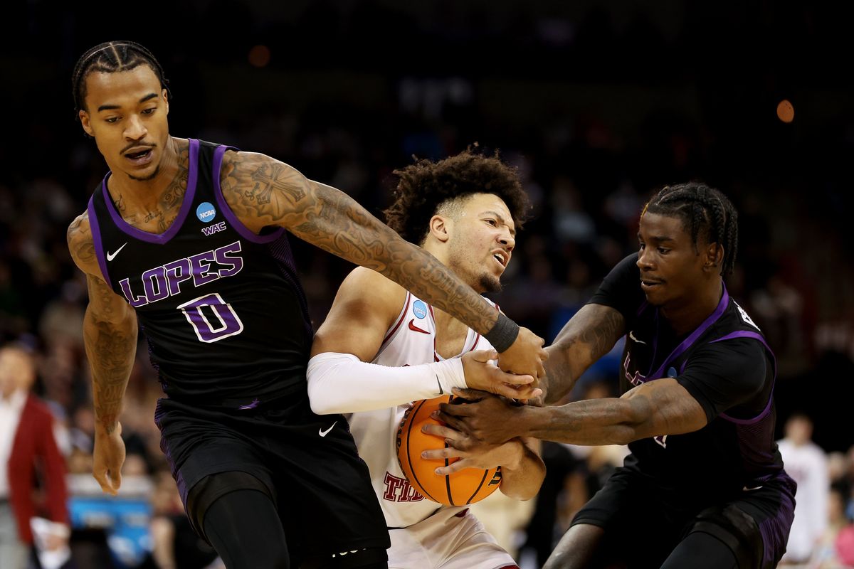Grand Canyon’s Ray Harrison, left, and Tyon Grant-Foster fight for the ball against Alabama’s Mark Sears during the NCAA Tournament on Sunday at the Arena.  (Getty Images)