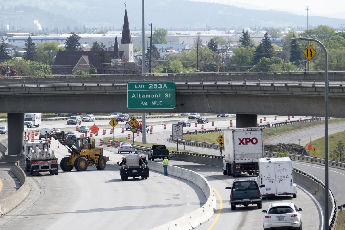 Work crews set up lane restricting barriers on eastbound Interstate 90 on the east end of downtown during morning rush hour  May 8. The restrictions are a start to a long repair project on the freeway. (Jesse Tinsley / The Spokesman-Review)