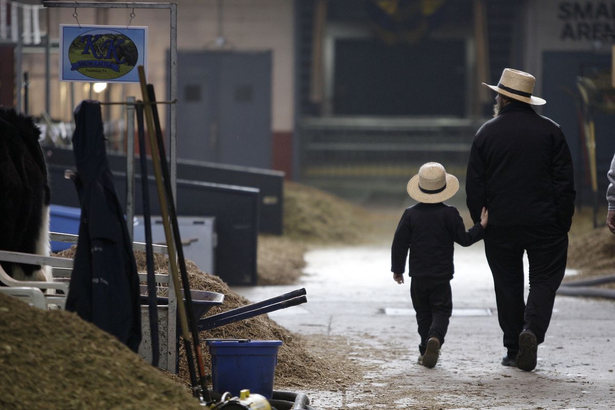 An Amish father and son tour the 93rd annual Pennsylvania Farm Show in Harrisburg, Pa. Nearly 20,000 people across the U.S. and Canada subscribe to The Budget, the dominant means of communication among the Amish. Associated Pres file photo (Associated Pres file photo / The Spokesman-Review)
