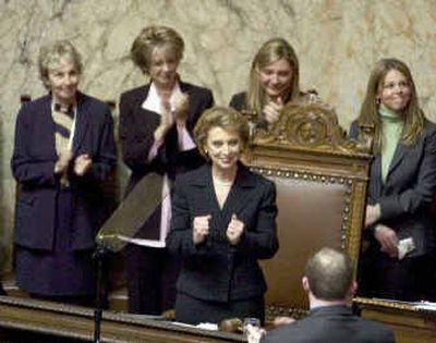 
After being sworn in Wednesday as the 22nd governor of Washington state, Gov. Christine Gregoire clenches her fists in a victory sign before giving her inaugural speech. 
 (Colin Mulvany / The Spokesman-Review)