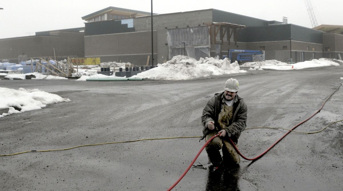 Bryan Shafer of Dempsey Masonry out of Spokane, Wash. fixes a leaky hose just outside the Kroc Community Center. (Kathy Plonka / The Spokesman-Review)