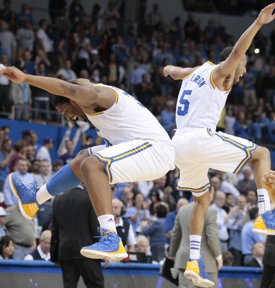 UCLA’s Joshua Smith, left, and Jerime Anderson celebrate after beating Washington 75-69 in Los Angeles on Saturday afternoon. (Associated Press)