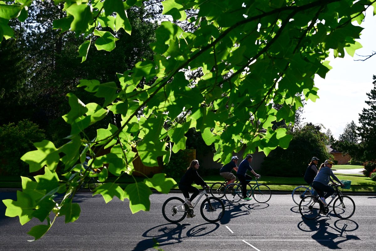 Cyclists cruise through the evening light during Summer Parkways on Wednesday at Comstock Park in Spokane,.  (Tyler Tjomsland/The Spokesman-Review)
