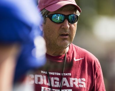 WSU coach Mike Leach looks over Saturday’s scrimmage. (Associated Press)