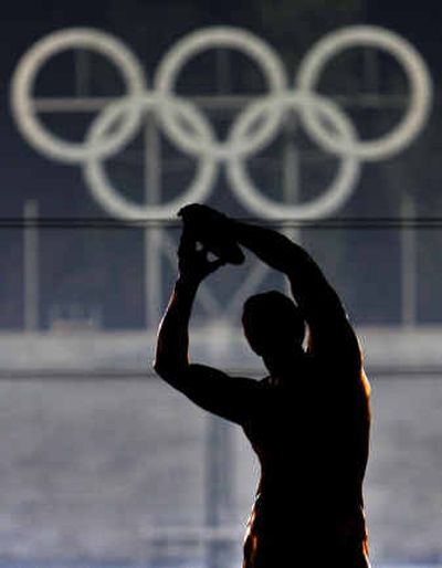 
The statue of a discus thrower stands in front of the Olympic rings in the Panathenian Marble Stadium in Athens. 
 (Associated Press / The Spokesman-Review)