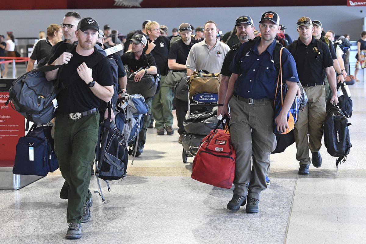 A contingent of 39 firefighters from the United states and Canada arrive at Melbourne Airport in Melbourne, Thursday, January 2, 2020. The firefighters will assist local crews with ongoing fires burning across Victoria. (Julian Smith / Associated Press)