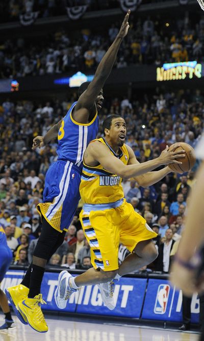 Nuggets guard Andre Miller contorts his body on the way to the winning basket in Game 1. (Associated Press)