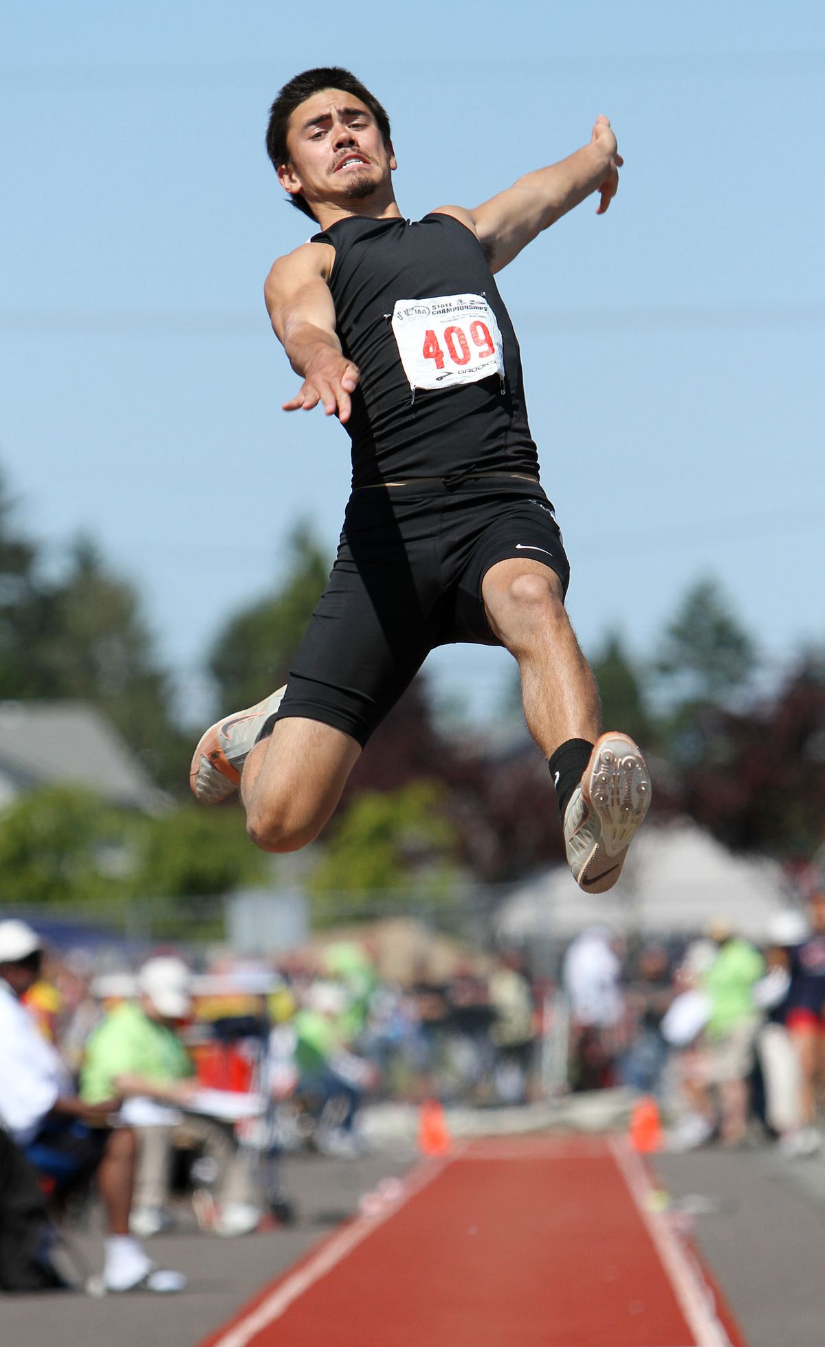 Lewis and Clark’s Brennan Schon flies through the air in long jump. He was fourth. (PATRICK HAGERTY)