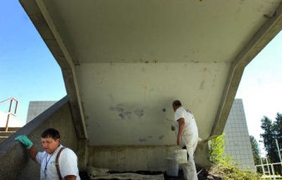 
District 81 painters Charlie Gordon, left, and Tom McCracken paint over graffiti at Gary Middle School on Friday. The men say they spent 1,050 hours last year cleaning graffiti. 
 (Jed Conklin / The Spokesman-Review)