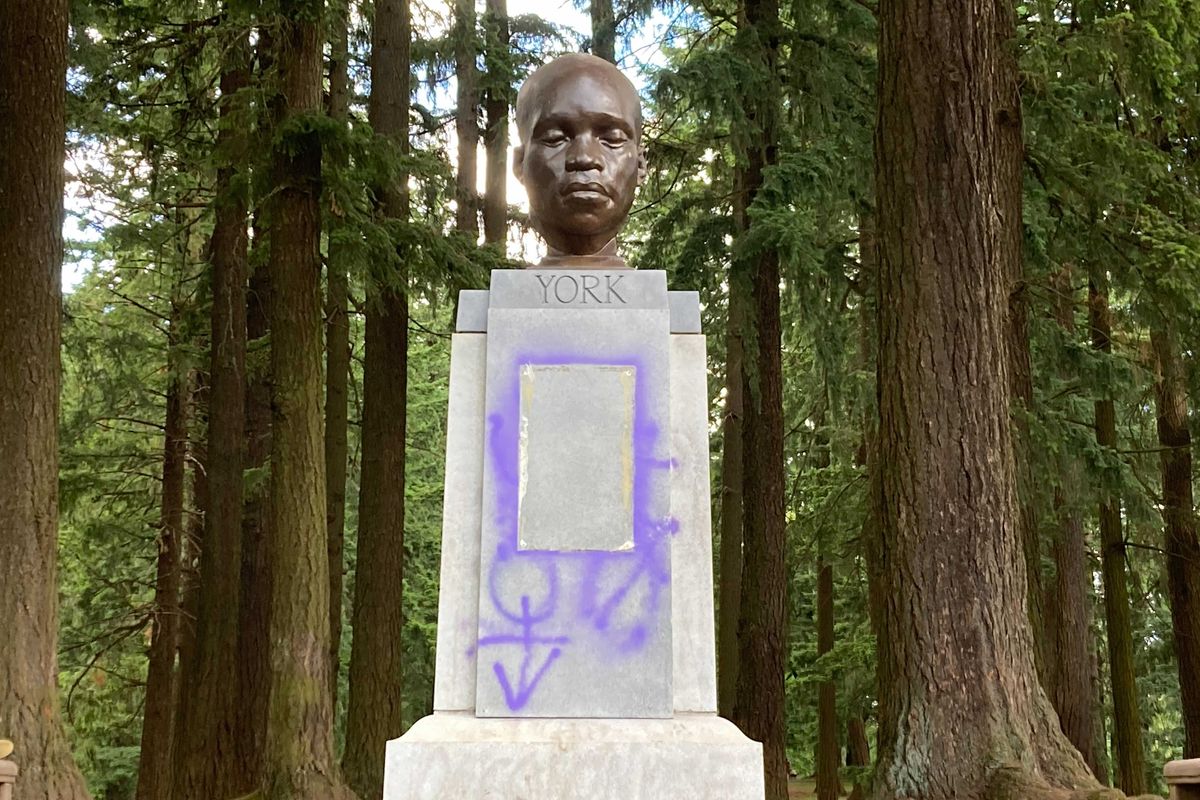 This Thursday, June 10, 2021 photo shows a statue commemorating York, an enslaved Black member of the Lewis and Clark Expedition, after being defaced in Portland, Ore.  (Catalina Gaitán)
