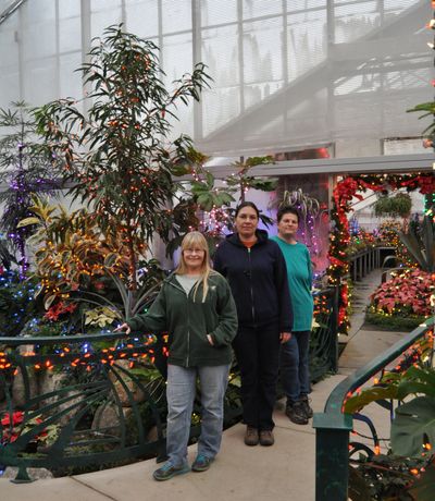 From left, Stephanie O’Byrne, Tara Newbury and Kathleen Miller are the creative and technical forces behind this year’s Holiday Lights display at the Gaiser Conservatory in Manito Park.