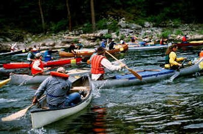 Paddlers splash out of Corbin Park at Post Falls into the Spokane River at the 2003 start of the annual Spokane River Canoe Classic. 
 (Rich Landers / The Spokesman-Review)