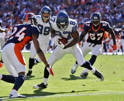 Seattle’s Ben Obomanu heads for the endzone on a 12-yard touchdown in the second half as Denver’s Champ Bailey (24) defends. (Associated Press)