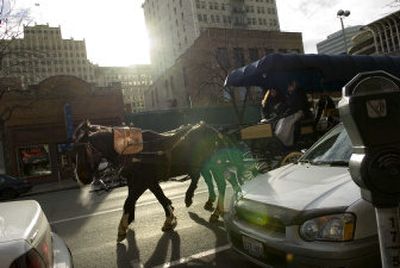 
Bruce and Donna Spencer lead their horses and carriage down Main Avenue in downtown Spokane on Saturday afternoon. The carriage ride is free and lasts 15 minutes. 
 (Holly Pickett / The Spokesman-Review)