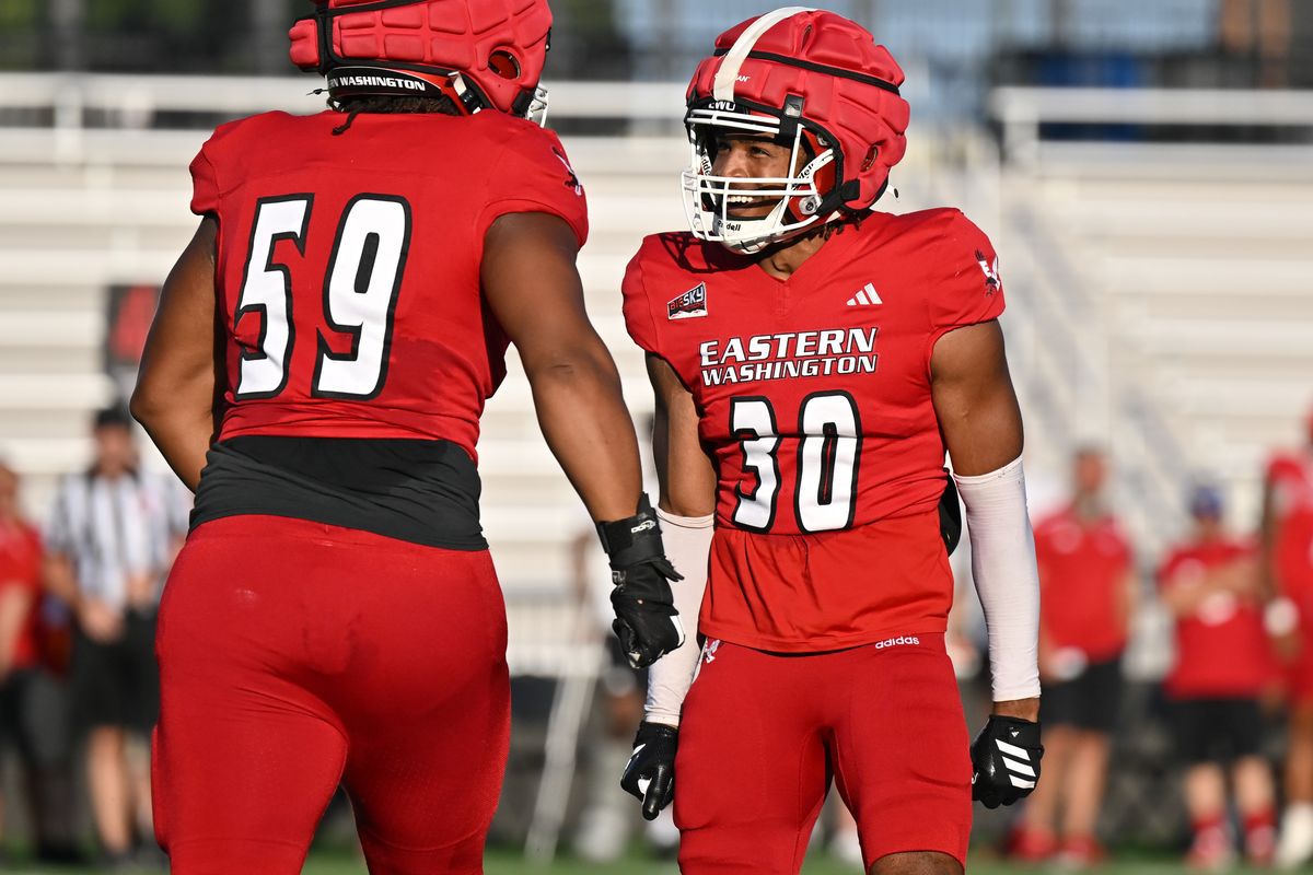Eastern Washington Eagles cornerback Jonathan Landry (30) celebrates with defensive lineman Clayton McCarrell (59) during a fall camp scrimmage on Thursday, Aug. 14, 2025, at ONE Spokane Stadium in Spokane, Wash.  (Tyler Tjomsland/The Spokesman-Review)