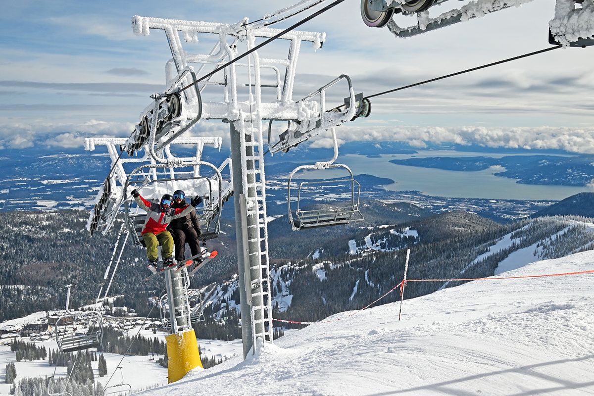 Two skiers take in the magnificent views at Schweitzer Mountain Resort.  (Schweitzer Mountain Resort/via Ski Magazine)