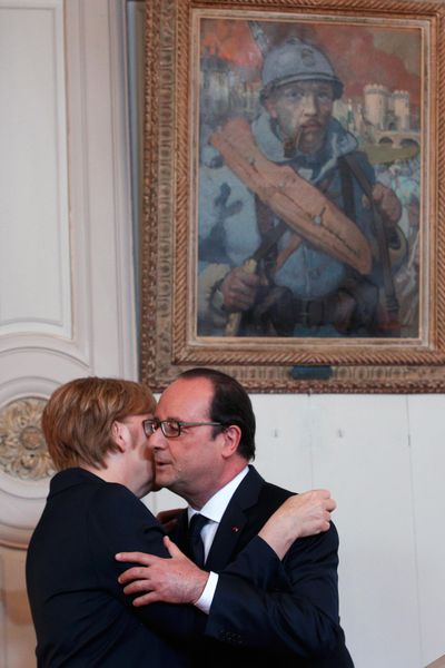 France’s President Francois Hollande hugs German Chancellor Angela Merkel, in Verdun, France, Sunday. (Thibault Camus / Associated Press)