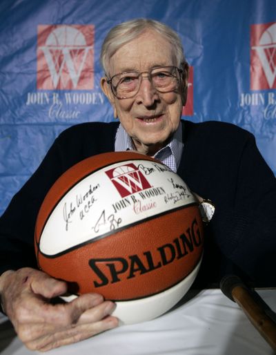 FILE - In this Dec. 9, 2005, file photo, Former UCLA basketball coach John Wooden poses for a picture after a news conference in Anaheim, Calif., about Saturday's Wooden Classic basketball tournament. Wooden, college basketball's gentlemanly Wizard of Westwood who built one of the greatest dynasties in all of sports at UCLA and became one of the most revered coaches ever, has died. He was 99. (Chris Carlson / Associated Press)