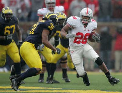 
Ohio State tailback Chris Wells runs toward Michigan's Brandent Englemon on Saturday. Associated Press
 (Associated Press / The Spokesman-Review)