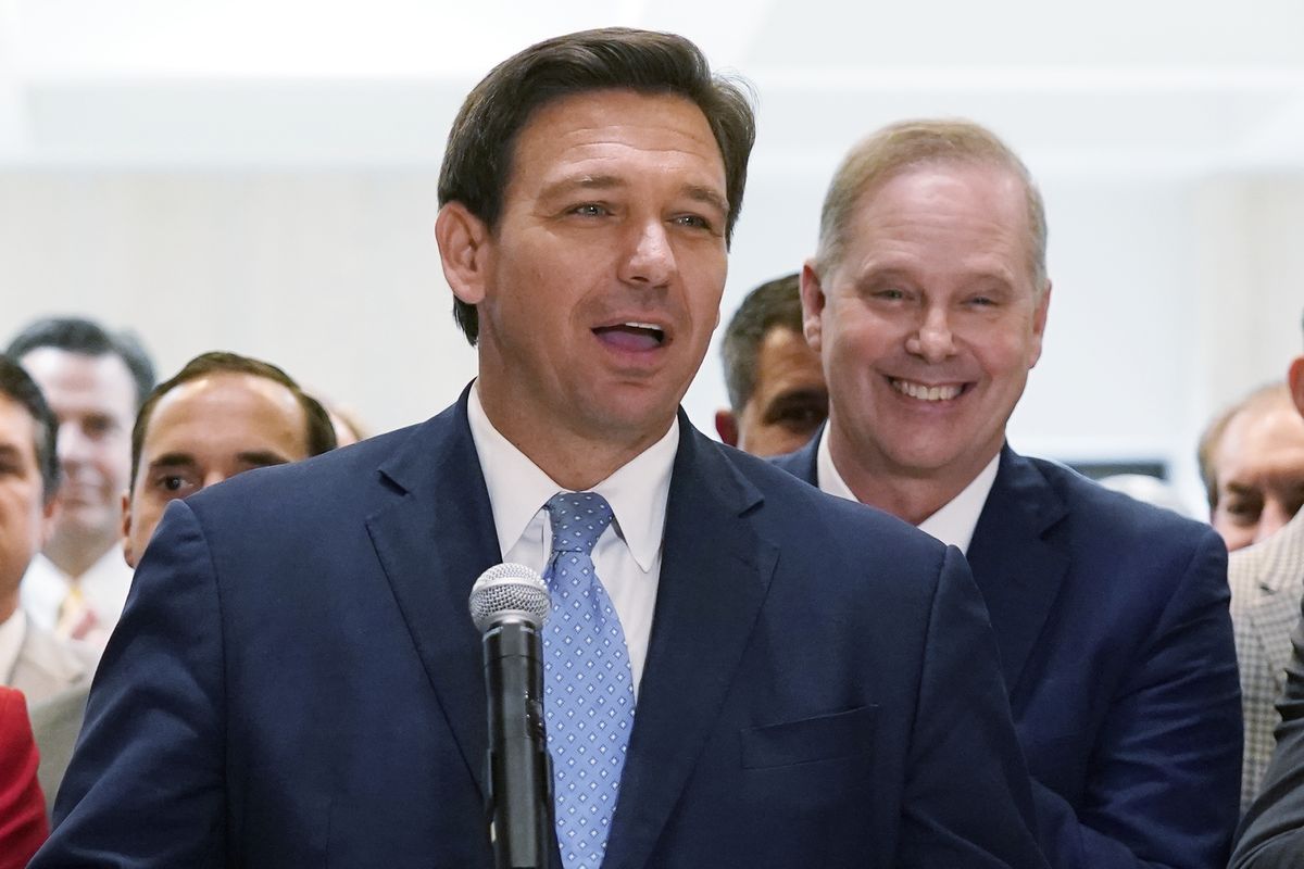 In this April 30, 2021 photo, surrounded by lawmakers, Florida Gov. Ron DeSantis speaks at the end of a legislative session at the Capitol in Tallahassee, Fla. Now that the pandemic appears to be waning and DeSantis is heading into his reelection campaign next year, he has emerged from the political uncertainty as one of the most prominent Republican governors and an early White House front-runner in 2024 among Donald Trump