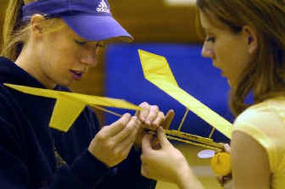 Colton High School seniors Casey Riedner, left, and Jessica Blamires prepare the plane they built for flight Saturday morning at Spokane Falls Community College. 
 (Holly Pickett / The Spokesman-Review)