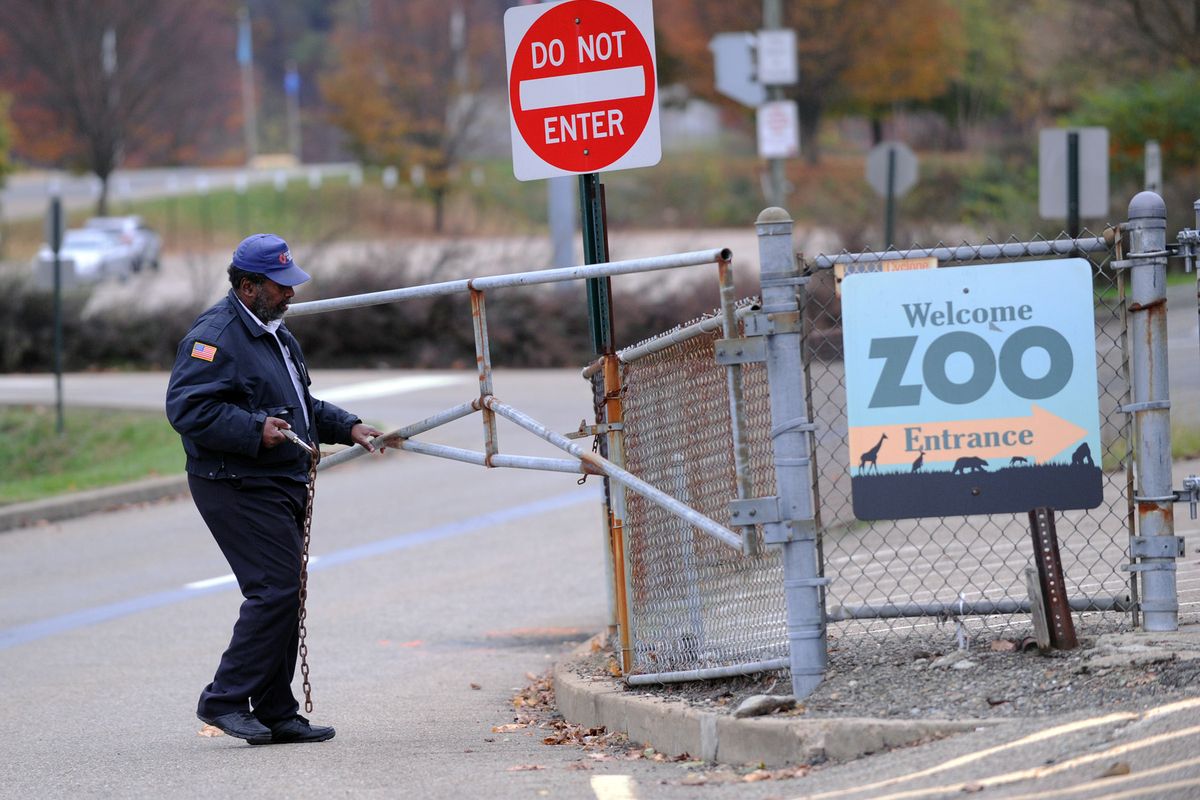 A security guard closes the gate at the Pittsburgh Zoo, where zoo officials say a young boy was killed after he fell into the exhibit that was home to a pack of African painted dogs, who pounced on the boy and mauled him, Sunday, Nov. 4, 2012. It�s not clear whether he died from the fall or the attack, said Barbara Baker, president and CEO of the Pittsburgh Zoo & PPG Aquarium. (John Heller / Fr48174 Ap)