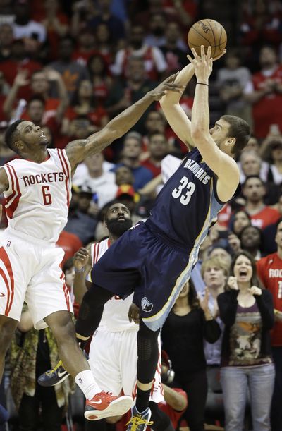 Memphis Grizzlies’ Marc Gasol, right, shoots a last-second shot over Terrence Jones to defeat the Houston Rockets 102-100. (Associated Press)