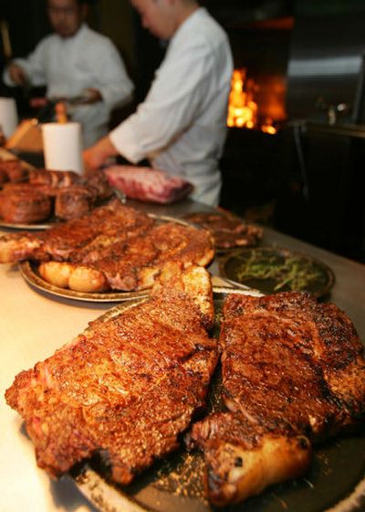 
Chefs prepare to grill American beef at a Tokyo restaurant Monday night. Released from a two-year-long ban over mad cow fears, imported American beef sizzled once again on Japanese grills. 
 (Associated Press photos / The Spokesman-Review)