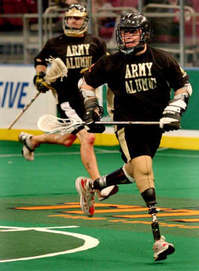 
John Fernandez, who lost the lower portion of his legs in Iraq in 2003, plays lacrosse Saturday during the Heroes Cup game between Army and Navy alumni. Associated Press photos
 (Associated Press photos / The Spokesman-Review)