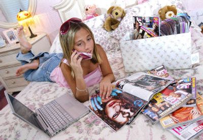 
Audriana Rossano, 11, checks out an issue of Us Weekly at her family's Cherry Hill, N.J., home recently. 
 (Associated Press / The Spokesman-Review)