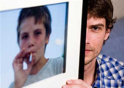 Photographer Maarten Dors shows his picture of a Romanian child smoking a cigarette entitled 
