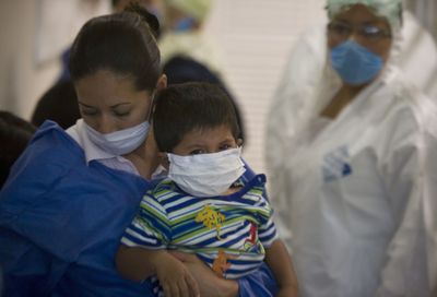 Wearing masks as a precaution against swine flu, patients wait for help Monday at the Naval Hospital in Mexico City.  (Associated Press / The Spokesman-Review)