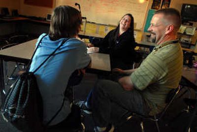 
Teresa Nicholson laughs at a conference Monday with her eighth-grade son Robert and his teacher Dave Paulson  at Shaw Middle School.  
 (Brian Plonka / The Spokesman-Review)