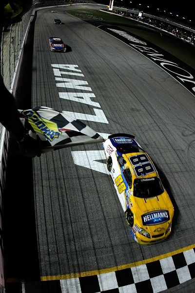 Jamie McMurray takes the checkered flag to win over Kyle Busch during Saturday’s NASCAR Nationwide Series Great Clips 300 at Atlanta Motor Speedway. Busch actually led the most laps of the race, three times for 74, while McMurray led three times for 48 laps. (Photo courtesy of Todd Warshaw/Getty Images) (Todd Warshaw / Getty Images North America)