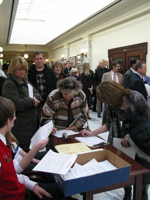 Idahoans sign in to testify at Tuesday's public hearing on school reform; it's the first of three days of public testimony on state schools Supt. Tom Luna's controversial reform plan, which calls for larger class sizes, more online courses, laptops for every high school student, and a pay-for-performance plan for teachers. (Betsy Russell)