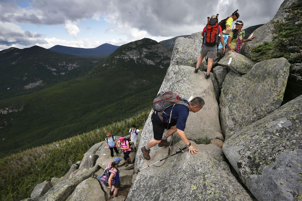 Hikers scramble on the Appalachian Trail up Mount Katahdin in Maine’s Baxter State Park. A sharp rise in trail users is causing headaches for officials. (Associated Press)