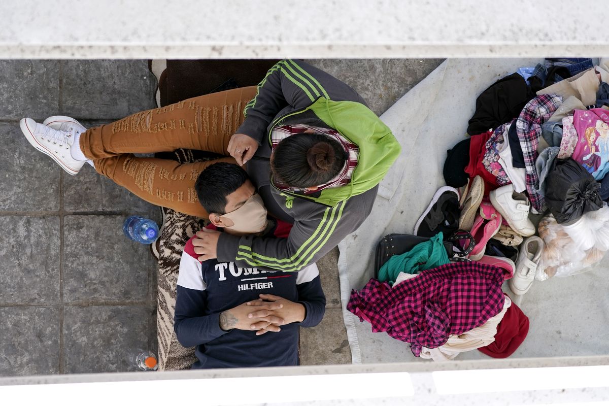 Migrants who were caught trying to sneak into the United States and deported rest under a ramp that leads to the McAllen-Hidalgo International Bridge point of entry into the U.S., Thursday, March 18, 2021, in Reynosa, Mexico. A surge of migrants on the Southwest border has the Biden administration on the defensive. The head of Homeland Security acknowledged the severity of the problem Tuesday but insisted it