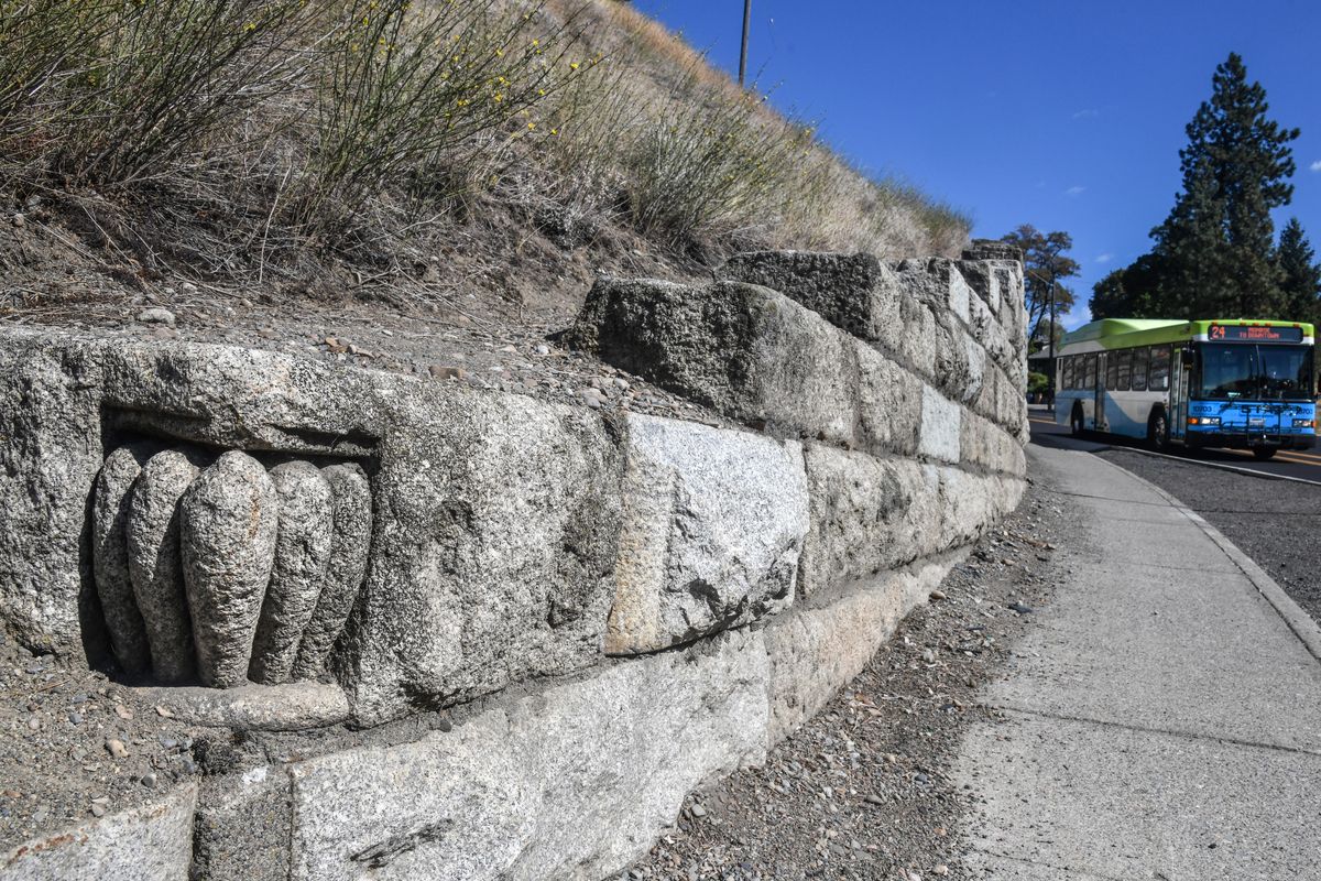 An ornamental flourish is positioned near the end of the North Monroe Street retaining wall in Spokane, Wash. Previous to 1929, the granite blocks made the old Granite Building downtown, where the Paulsen center is now. (Dan Pelle / The Spokesman-Review)