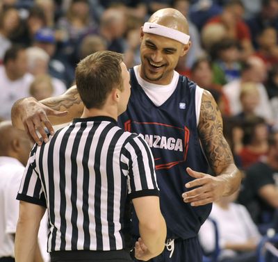 Robert Sacre has enough love to go around for everyone, even game officials during the Kraziness in the Kennel in October. (Dan Pelle)