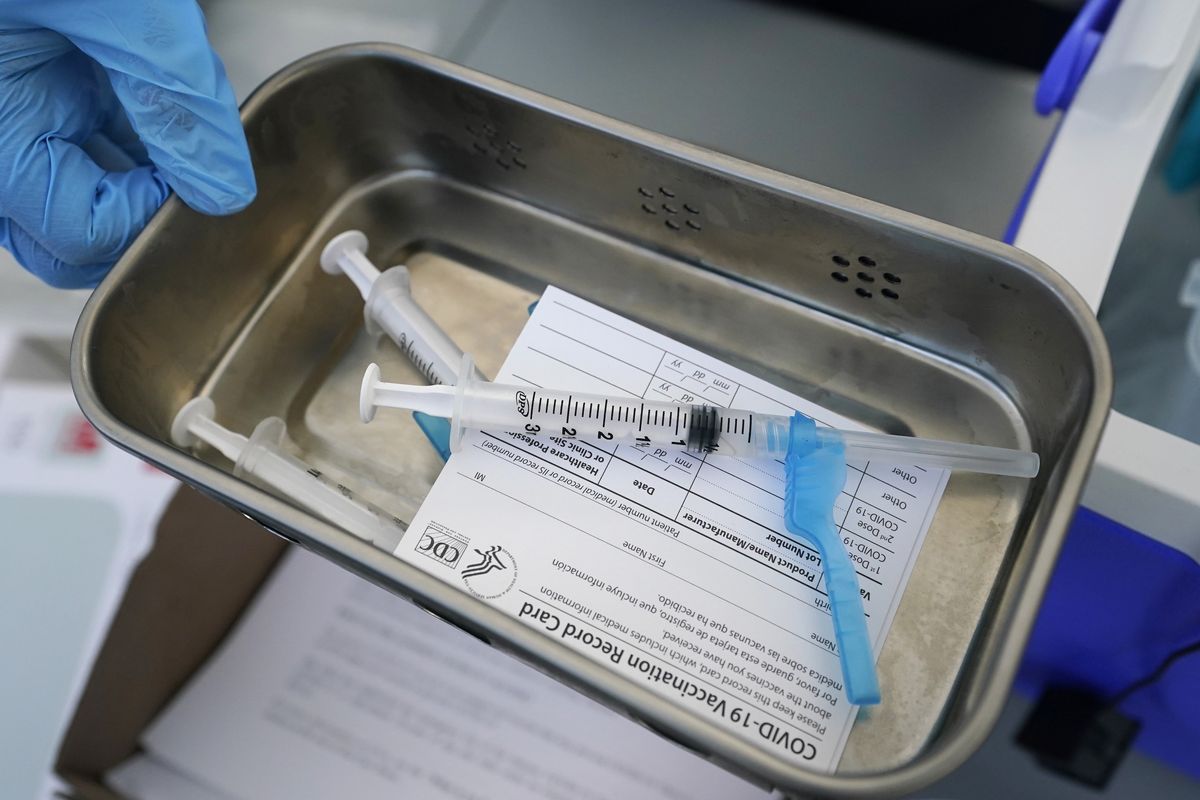This May 13, 2021 photo shows syringes filled with the Johnson & Johnson vaccine at a mobile vaccination site in Miami. Police departments that are requiring officers to be vaccinated against COVID-19 are running up against pockets of resistance across the U.S.  (Wilfredo Lee)