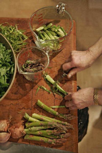 
Cookbook author Barbara Kafka peels asparagus stalks as she prepares ingredients for making Pasta with Asparagus Sauce, one of the recipes in her cookbook 