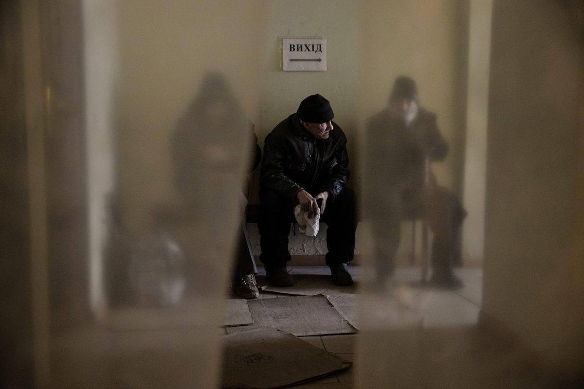 Men wait to meet volunteers at a humanitarian aid hub in Bakhmut, Ukraine on Thursday, Dec. 1, 2022. Few residents remain in the frontline city of Bakhmut, which is without electricity and under daily attack by the Russian military as freezing winter temperatures set in. (Tyler Hicks/The New York Times)  (TYLER HICKS)