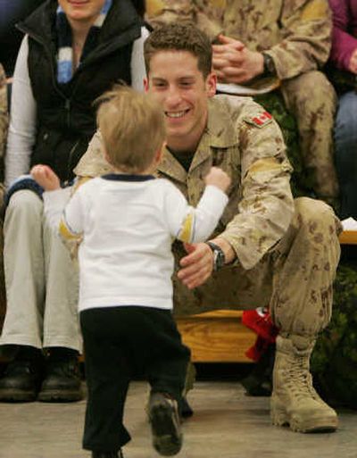 
Then-Lt. Matthew Dawe reaches out for his son, Lucas, 1, during a February briefing in Edmonton. Dawe was one of six Canadian solders killed by a roadside bomb Wednesday.Associated Press
 (File Associated Press / The Spokesman-Review)
