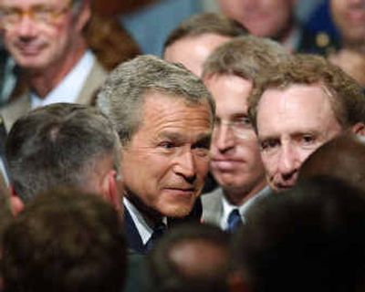 
President Bush joins Sen. Arlen Specter, R-Pa., right, in greeting members of the audience at the U.S. Army War College in Carlisle, Pa., on Monday.
 (Associated Press / The Spokesman-Review)