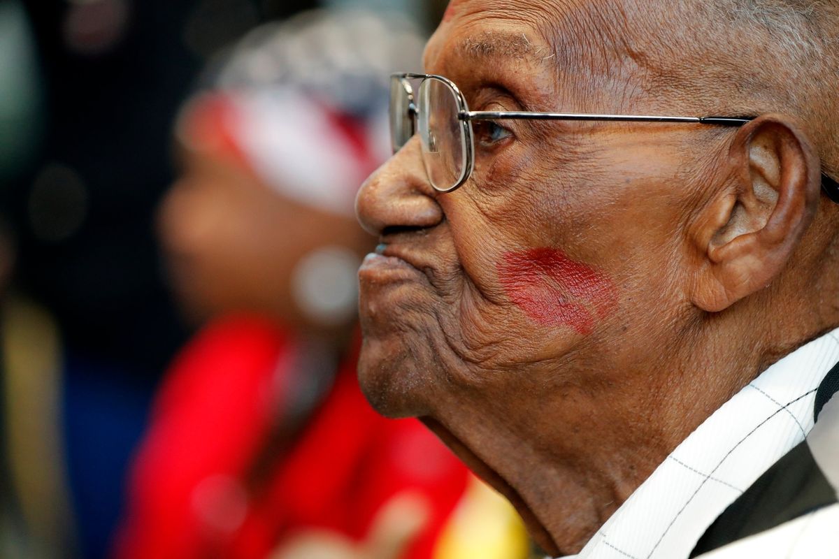 World War II veteran Lawrence Brooks sports a lipstick kiss on his cheek, planted by a member of the singing group Victory Belles, as he celebrates his 110th birthday at the National World War II Museum in New Orleans, Thursday, Sept. 12, 2019. The oldest World War II veteran in the United States has died at the age of 112. Lawrence N. Brooks died Wednesday, Jan. 5, 2022 in New Orleans. His death was announced by the National World War II Museum and confirmed by his daughter.  (Associated Press)